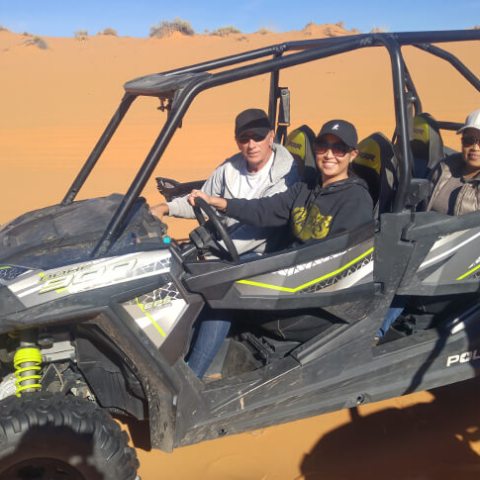 a group of people riding on the back of a truck