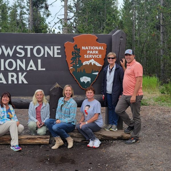 a group of people standing in front of a sign