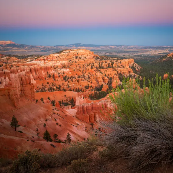 a canyon with Bryce Canyon National Park in the background