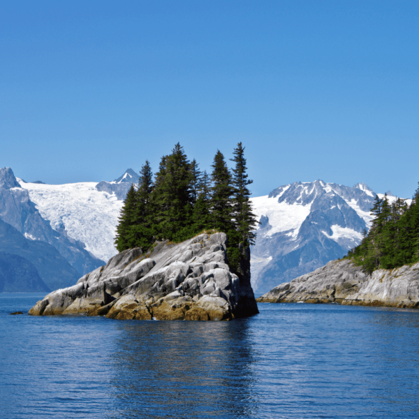 an island in the middle of a lake surrounded by snow