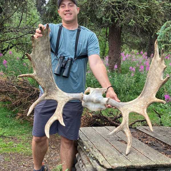 a statue of a man and a woman standing in front of a tree