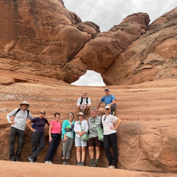 a group of people standing on a rock