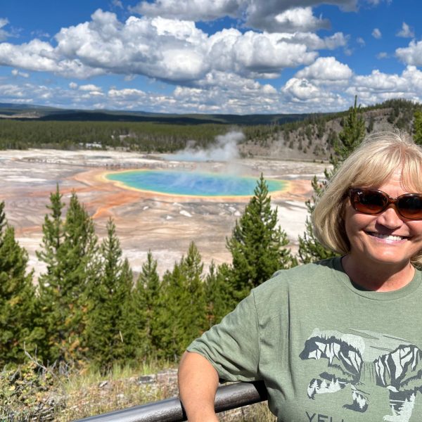 a man standing in front of a body of water