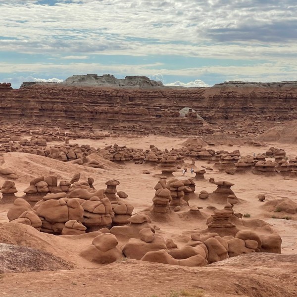 a rocky beach with Goblin Valley State Park in the background