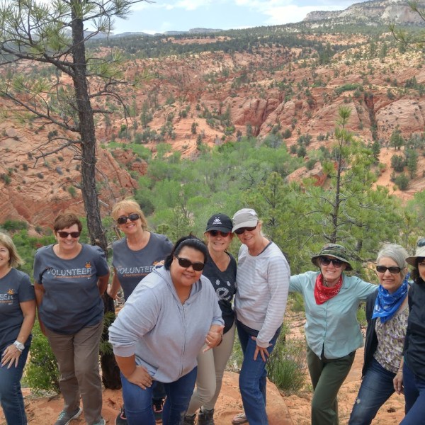 a group of people standing on top of a mountain